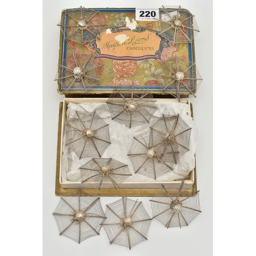 220 - A SET OF TWELVE NOVELTY WHITE METAL OCTAGONAL  FILIGREE EASEL BACK PLACE NAME HOLDERS IN THE FORM OF... 