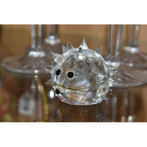 314 - FOUR MARQUIS BY WATERFORD CHAMPAGNE FLUTES AND A SWAROVSKI CRYSTAL HEDGEHOG, the Waterford glasses i... 