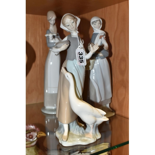 335 - A GROUP OF THREE LLADRO FIGURINES, comprising 4591 'Girl With a Cockerill', 4595 'Girl with Lamb' an... 