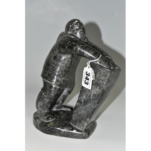 343 - A CANADIAN INUIT SOAPSTONE CARVING, of an Inuit fisherman, height approx. 20cm, inscribed marks to b... 