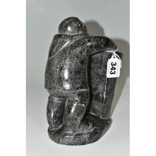 343 - A CANADIAN INUIT SOAPSTONE CARVING, of an Inuit fisherman, height approx. 20cm, inscribed marks to b... 