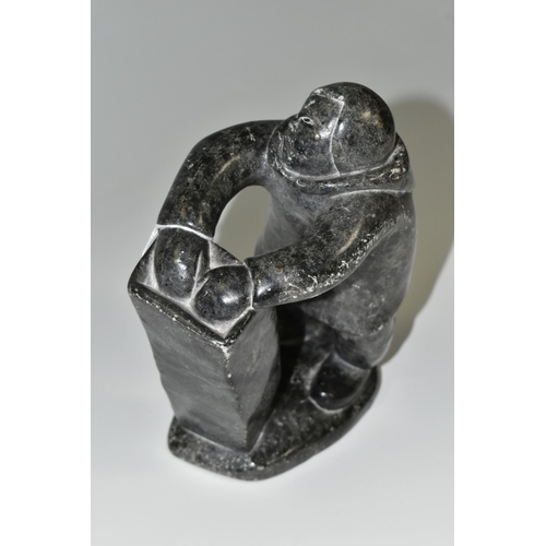 343 - A CANADIAN INUIT SOAPSTONE CARVING, of an Inuit fisherman, height approx. 20cm, inscribed marks to b... 