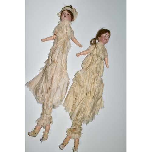 393 - TWO BISQUE HEAD DOLL PARASOLS, doll heads with composition lower limbs, hands and feet (in leather b... 