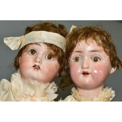 393 - TWO BISQUE HEAD DOLL PARASOLS, doll heads with composition lower limbs, hands and feet (in leather b... 