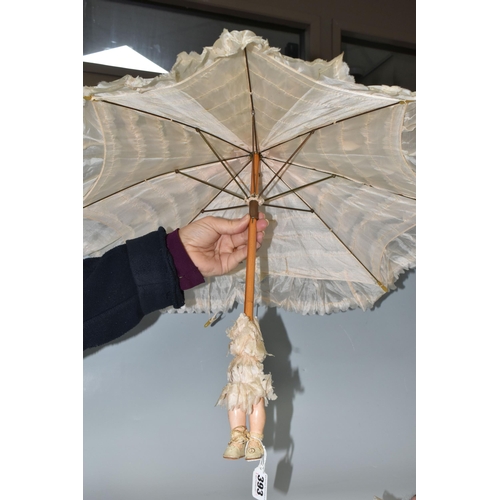 393 - TWO BISQUE HEAD DOLL PARASOLS, doll heads with composition lower limbs, hands and feet (in leather b... 