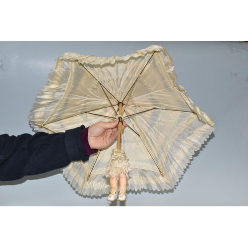 393 - TWO BISQUE HEAD DOLL PARASOLS, doll heads with composition lower limbs, hands and feet (in leather b... 