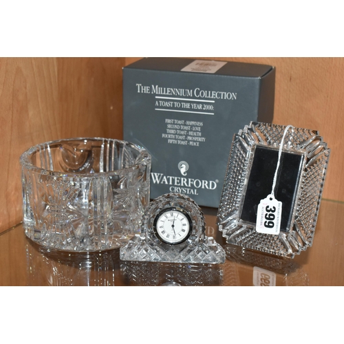 399 - THREE PIECES OF WATERFORD CRYSTAL, to include a boxed The Millennium Collection champagne bottle coa... 