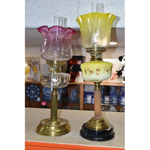 404 - TWO VICTORIAN OIL LAMPS, one has an etched yellow glass shade, moulded yellow milk glass reservoir h... 