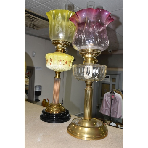 404 - TWO VICTORIAN OIL LAMPS, one has an etched yellow glass shade, moulded yellow milk glass reservoir h... 