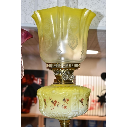 404 - TWO VICTORIAN OIL LAMPS, one has an etched yellow glass shade, moulded yellow milk glass reservoir h... 