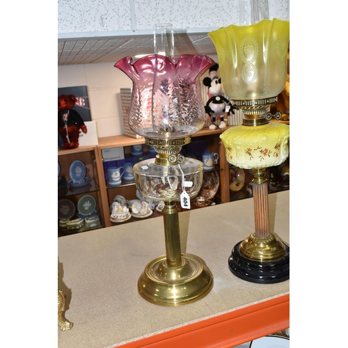 404 - TWO VICTORIAN OIL LAMPS, one has an etched yellow glass shade, moulded yellow milk glass reservoir h... 