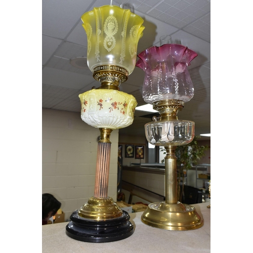 404 - TWO VICTORIAN OIL LAMPS, one has an etched yellow glass shade, moulded yellow milk glass reservoir h... 