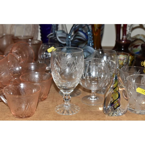 473 - A QUANTITY OF COLOURED GLASSWARE, comprising a Caithness pink swirl heart shaped trinket dish, Tutbu... 