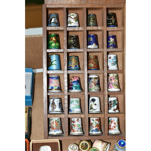 502 - A BOX OF GLASS, CERAMIC AND METAL COLLECTORS THIMBLES, to include forty-three boxed examples, Britis... 