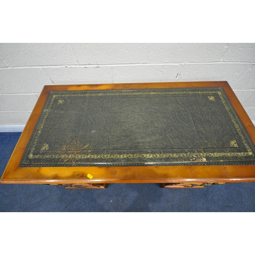 1198 - A 20TH CENTURY YEW WOOD TWIN PEDESTAL DESK, with a green tooled leather writing surface, fitted with... 