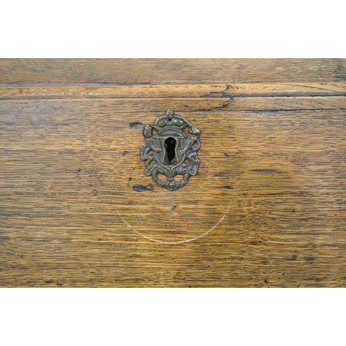 1200 - A GEORGIAN OAK BUREAU, the fall front door enclosing a fitted interior and green baize, above two sh... 