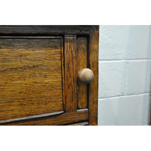 1200 - A GEORGIAN OAK BUREAU, the fall front door enclosing a fitted interior and green baize, above two sh... 