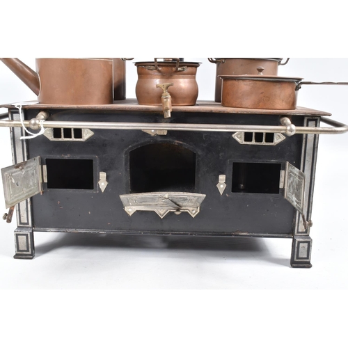 109 - A GERMAN MADE TINPLATE AND STEEL TOY OVEN AND STOVE, with three opening oven doors and set of six co... 