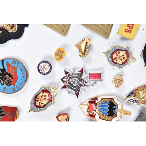 436 - A COLLECTION OF MIXED MILITARIA, to include cloth insignia, Russian badges that consist of a KEB hon... 