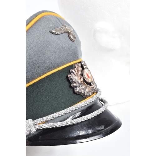 453 - A GERMAN WEHRMACHT CALVARY VISOR CAP, this is grey with a green centre band and three rows of yello ... 