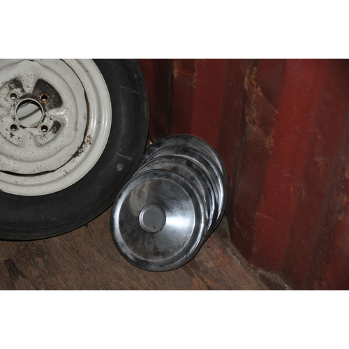 1006 - A SET OF FOUR 14in STEEL RIMS from Triumph Spitfire all with tyres from Zimbabwe and four chromed hu... 