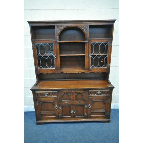 1203 - A 20TH CENTURY OAK OLD CHARM DRESSER, the top fitted with two lead glazed doors and an arrangement o... 