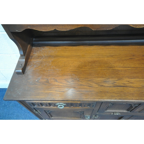 1203 - A 20TH CENTURY OAK OLD CHARM DRESSER, the top fitted with two lead glazed doors and an arrangement o... 