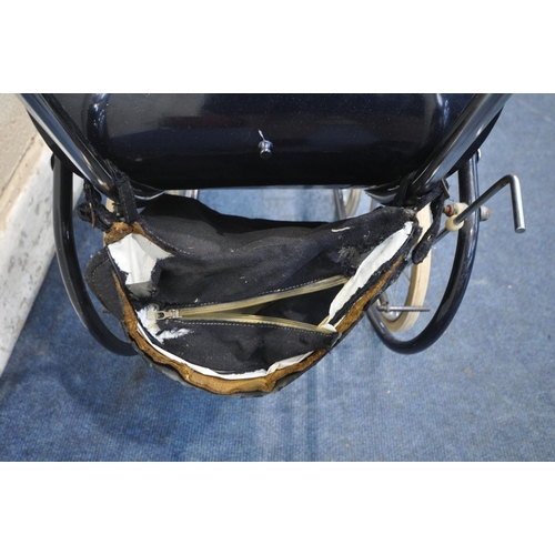 1210 - A DARK BLUE VINTAGE SILVER CROSS STYLE CHILDS PRAM, with a crown symbol to each side, along with a c... 