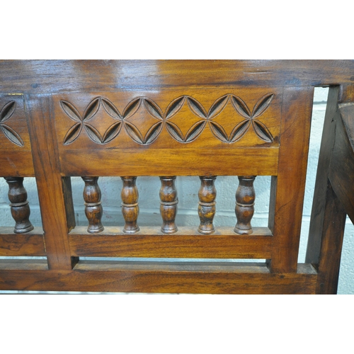 1211 - AN ANGLO INDIAN COLONIAL STYLE HARDWOOD CHILDS BENCH, carved with geometric designs, scrolled armres... 