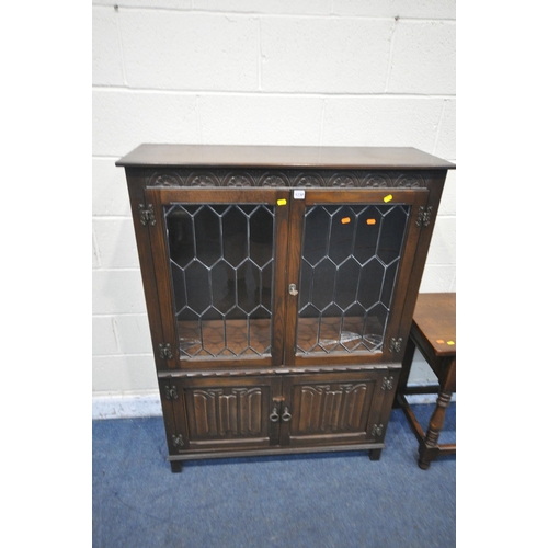 1230 - A 20TH CENTURY OAK JAYCEE BOOKCASE, with double lead glazed doors above double linenfold doors, widt... 