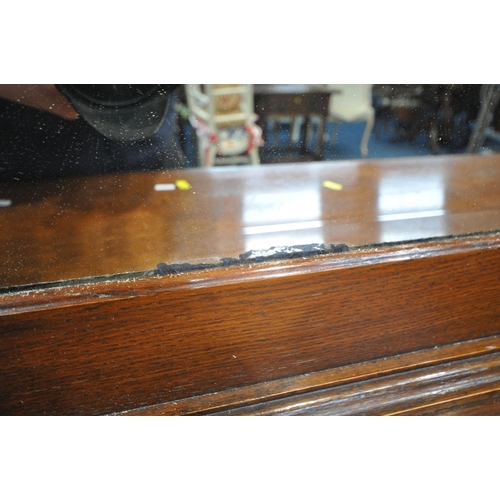 1236 - A 20TH CENTURY OAK MIRROR BACK SIDEBOARD, with an arched bevelled mirror plate, flanked by twin turn... 