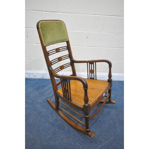 1241 - A 20TH CENTURY CANE SEATED ROCKING CHAIR, with green upholstered head rest, and geometric ladderback... 