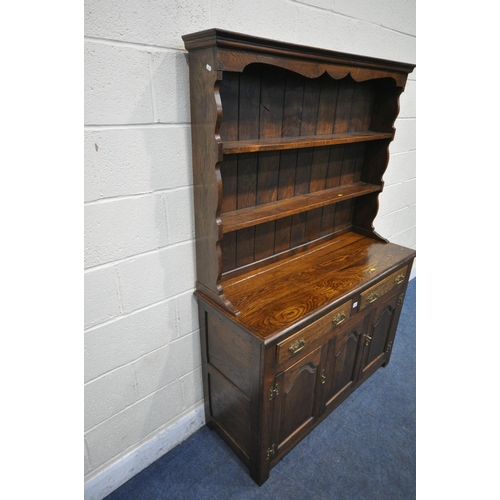 1247 - A GOOD QUALITY REPRODUCTION OAK DRESSER, the top two tier plate rack, on a base with two drawers and... 