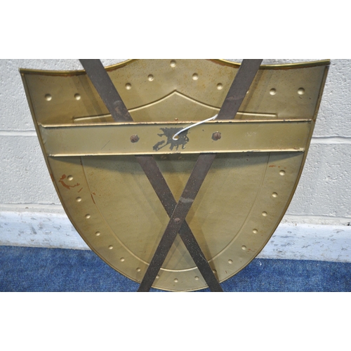 1248 - A DECORATIVE HANGING COPPER SHIELD, with brass trim and coat of arms, cross swords to rear, width 41... 