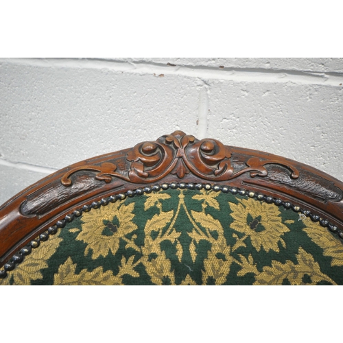 1300 - TWO SIMILAR VICTORIAN WALNUT LADIES AND GENTS SPOON BACK CHAIRS, with scrolled and foliate carving t... 