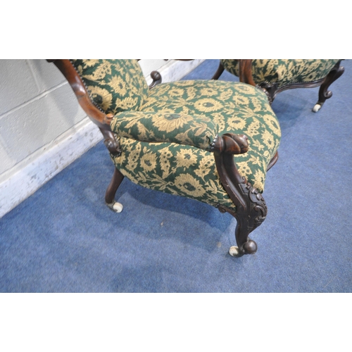 1300 - TWO SIMILAR VICTORIAN WALNUT LADIES AND GENTS SPOON BACK CHAIRS, with scrolled and foliate carving t... 