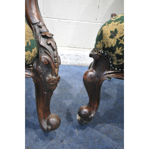 1300 - TWO SIMILAR VICTORIAN WALNUT LADIES AND GENTS SPOON BACK CHAIRS, with scrolled and foliate carving t... 