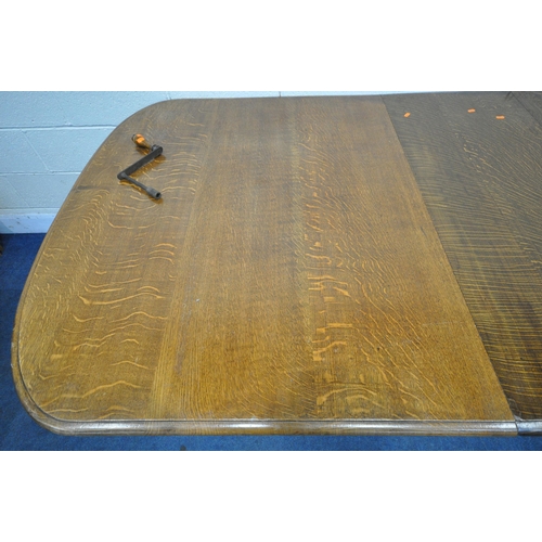 1321 - A LATE 19TH / EARLY 20TH CENTURY OAK WIND OUT DINING TABLE, with rounded ends, two additional leaves... 