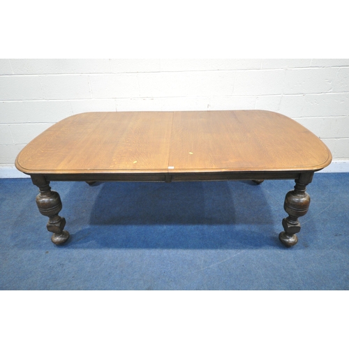 1321 - A LATE 19TH / EARLY 20TH CENTURY OAK WIND OUT DINING TABLE, with rounded ends, two additional leaves... 