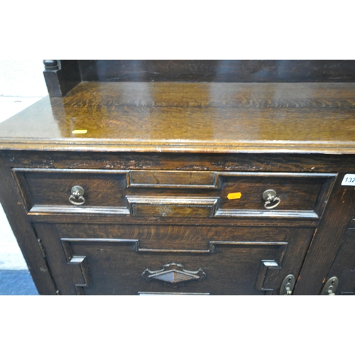 1326 - A 20TH CENTURY OAK DRESSER, the top with a single door and an arrangement of shelving, the base fitt... 