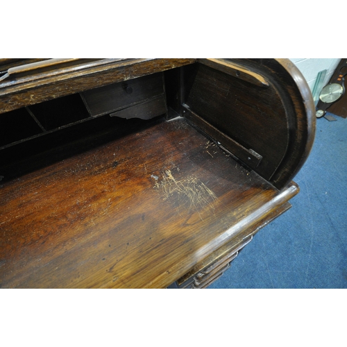 1328 - A 20TH CENTURY OAK ROLL TOP DESK, with a fitted interior, above an arrangement of five drawers and t... 