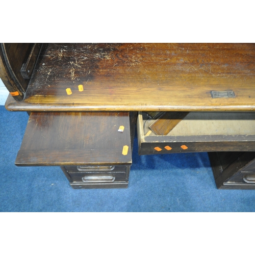 1328 - A 20TH CENTURY OAK ROLL TOP DESK, with a fitted interior, above an arrangement of five drawers and t... 