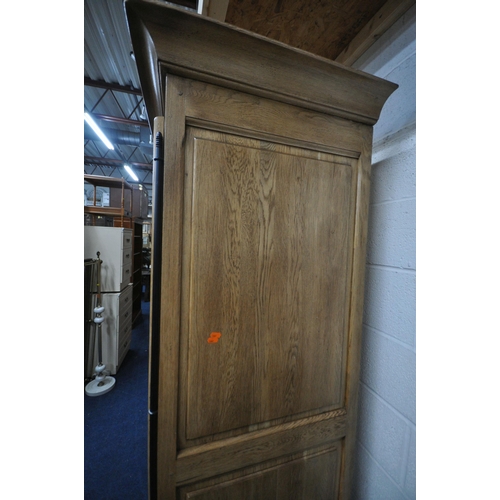 1329 - A LARGE GOOD QUALITY LIGHT OAK TRIPLE DOOR WARDROBE, with a fixed cornice, an arrangement of interna... 