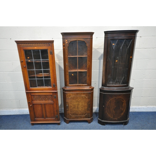 1338 - A WALNUT CORNER CUPBOARD, with a glazed door, that's enclosing two shelves, above a cupboard door, w... 