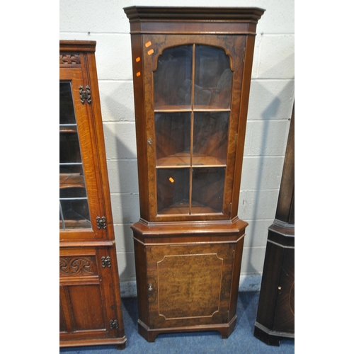 1338 - A WALNUT CORNER CUPBOARD, with a glazed door, that's enclosing two shelves, above a cupboard door, w... 