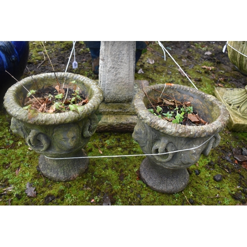 1009 - A WEATHERED COMPOSITE BIRD BATH, height 46cm, along with a pair of small garden urns, diameter 26cm ... 