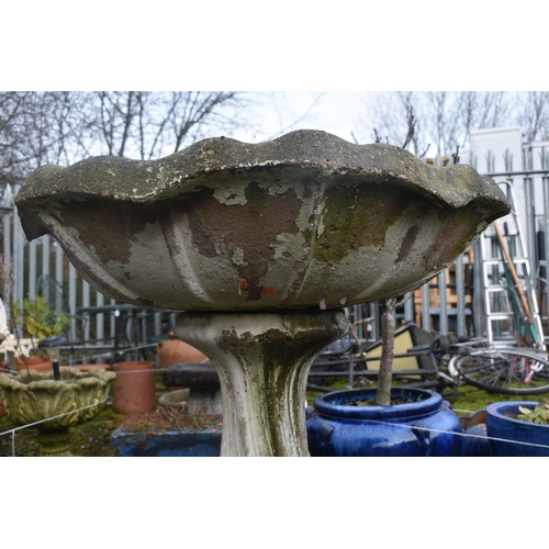 1016 - A LARGE WEATHERED COMPOSITE BIRD BATH, on a spiral base, diameter 89cm x height 64cm (condition repo... 