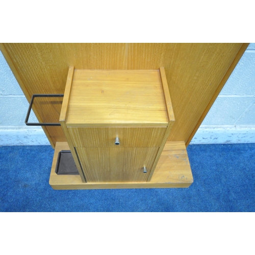 1269 - A 20TH CENTURY TEAK HALL STAND, with clothes rails, three brass hooks, a shaped mirror, a single dra... 