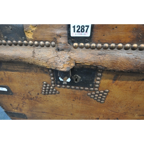 1287 - A VICTORIAN TANNED LEATHER TRUNK, with metal banding, twin leather handles and studded details, labe... 