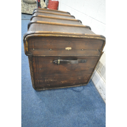 1290 - A LARGE VINTAGE CANVAS TRAVELING TRUNK, with bentwood banding, twin leather handles and a small plaq... 